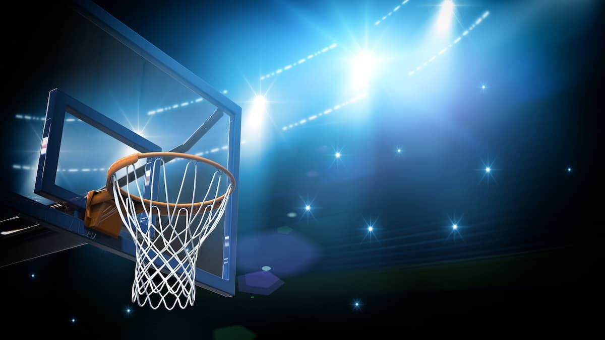 Basketball hoop in stadium at night