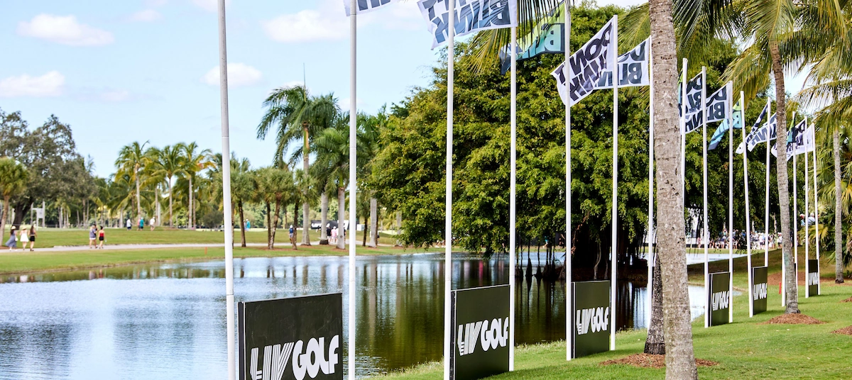 LIV Golf tournament, with flags next to a lake.