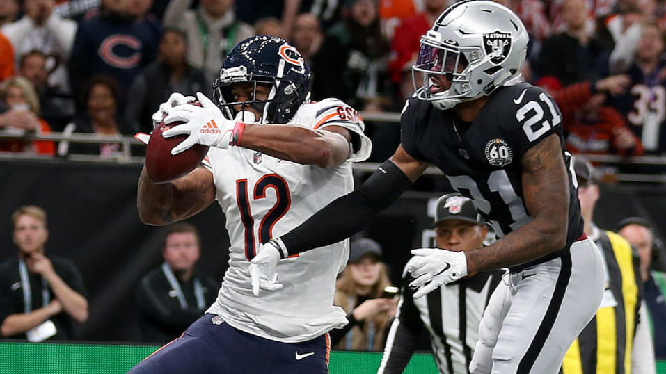 NFL players from the Chicago Bears and Las Vegas Raiders fight for the ball.