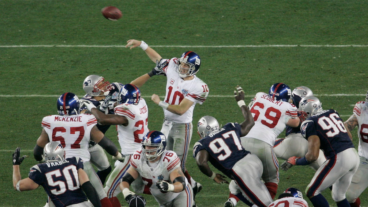 Eli Manning throws the ball under pressure from the Patriots during the Super Bowl.