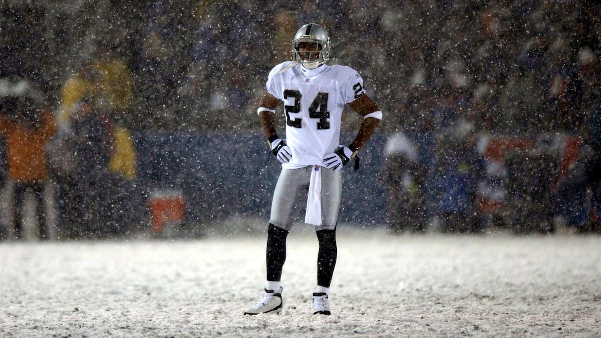 Rod Woodson of the Raiders standing in a snow-covered NFL field.