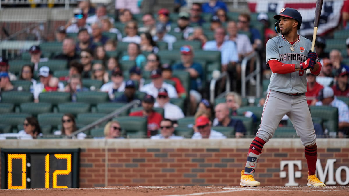 Washington Nationals outfielder Eddie Rosario prepares to hit in front of the pitch clock.