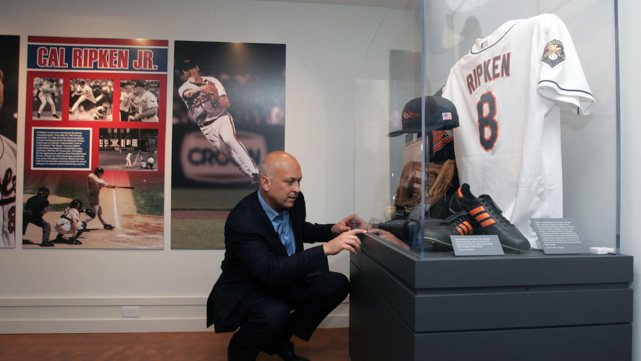 Cal Ripken looking at items from his MLB career at the Baseball Hall of Fame.