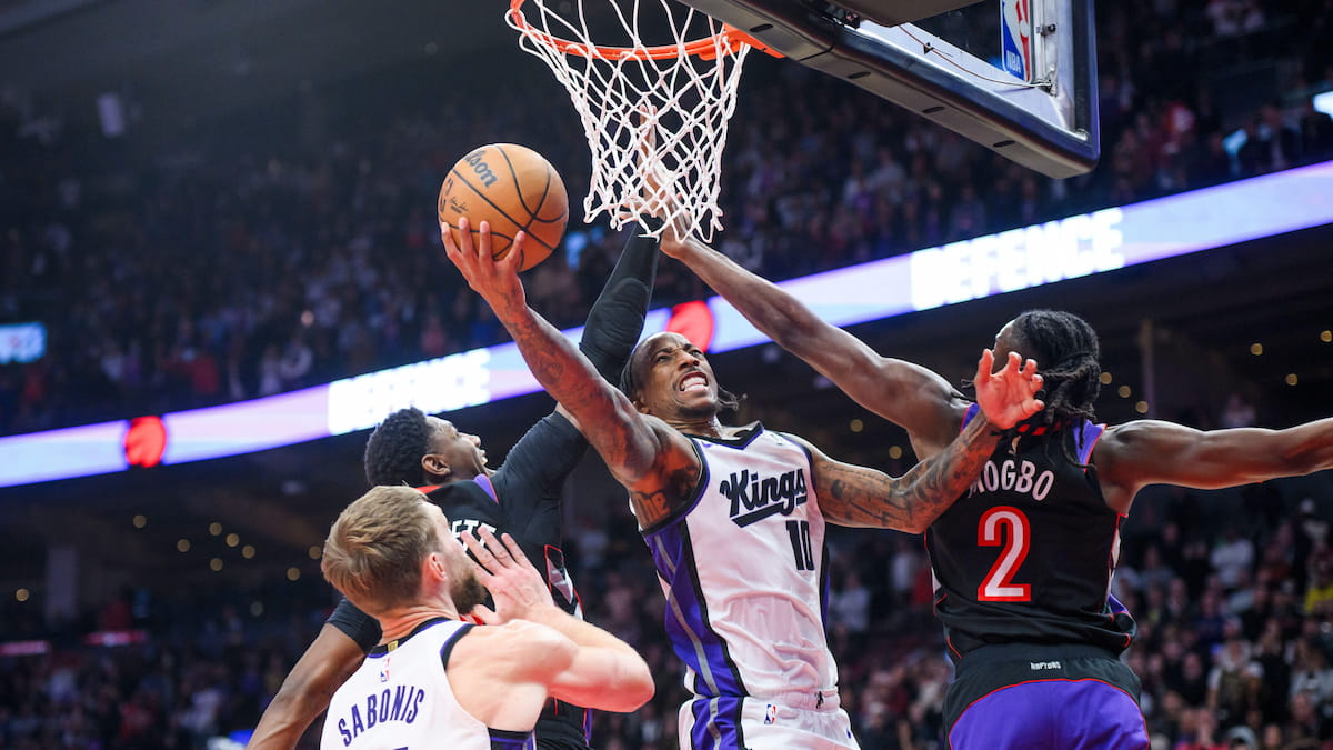 Sacramento Kings forward DeMar DeRozan (10) goes up for a layup while defended by Toronto Raptors players