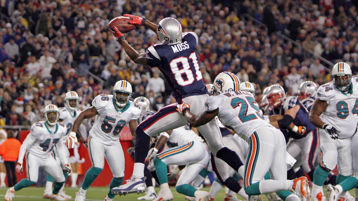 Randy Moss scoring a touchdown for the Patriots over the Dolphins.