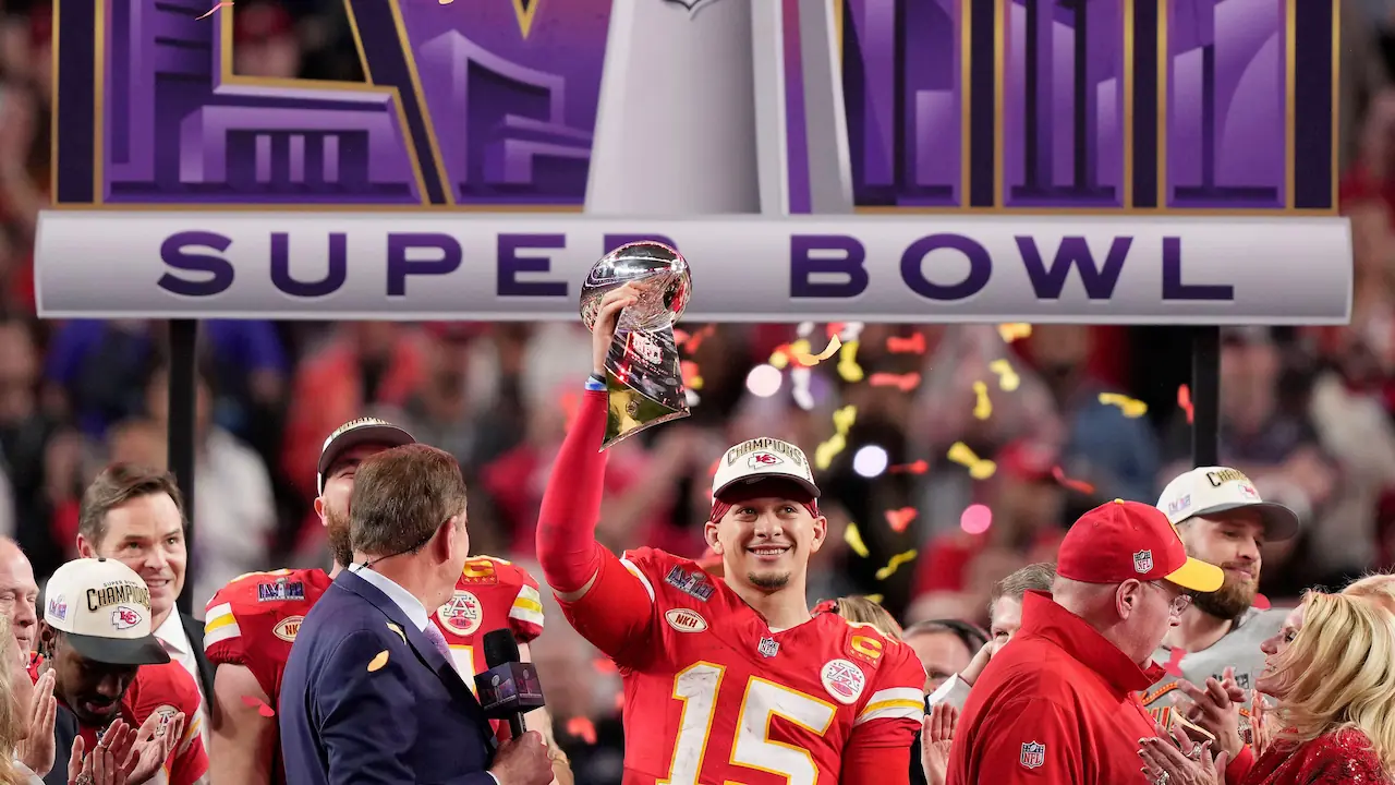 Patrick Mahomes holds up the Lombardi trophy after winning Super Bowl LVIII