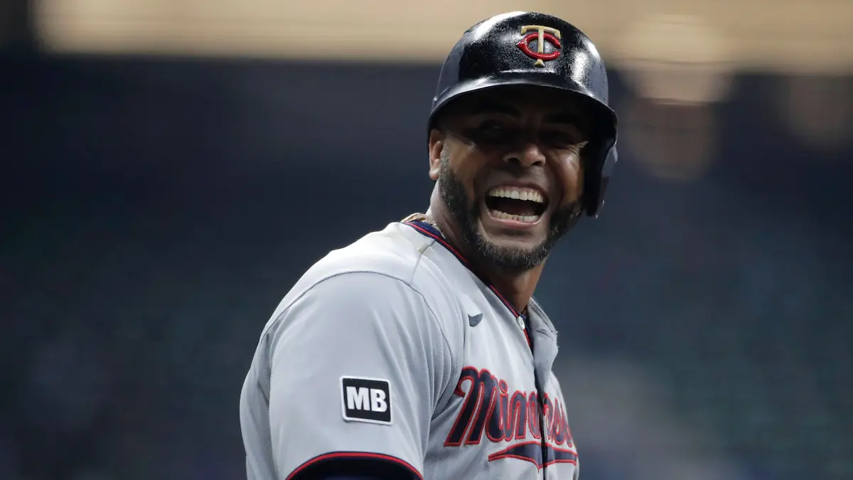 Minnesota Twins' Nelson Cruz laughing during a baseball game.