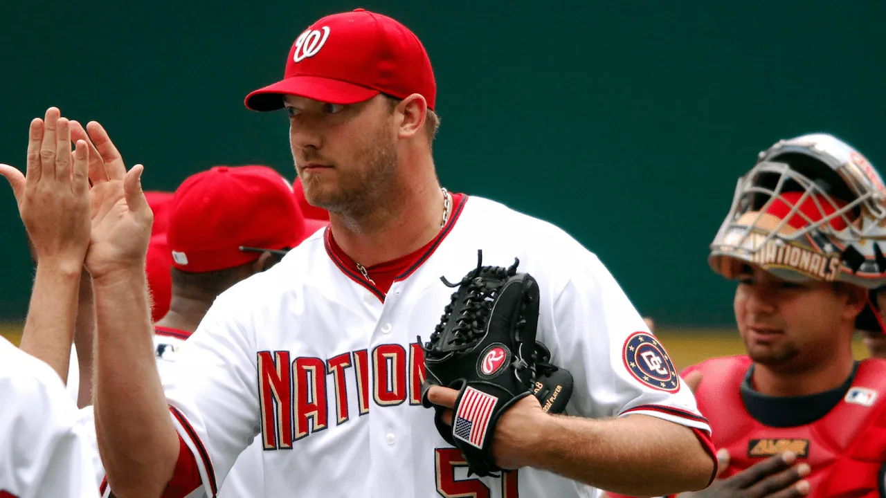 Jon Rauch high-fives teammates while playing for the Washington Nationals as a pitcher.